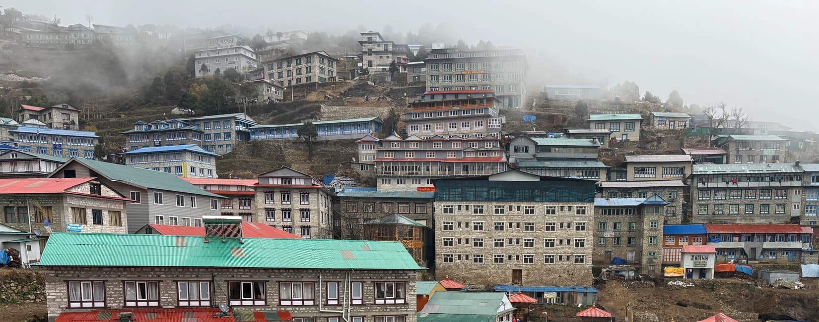 Misty view of Namche Bazaar, the famous Sherpa village and essential acclimatization stop for Mount Everest trekkers.